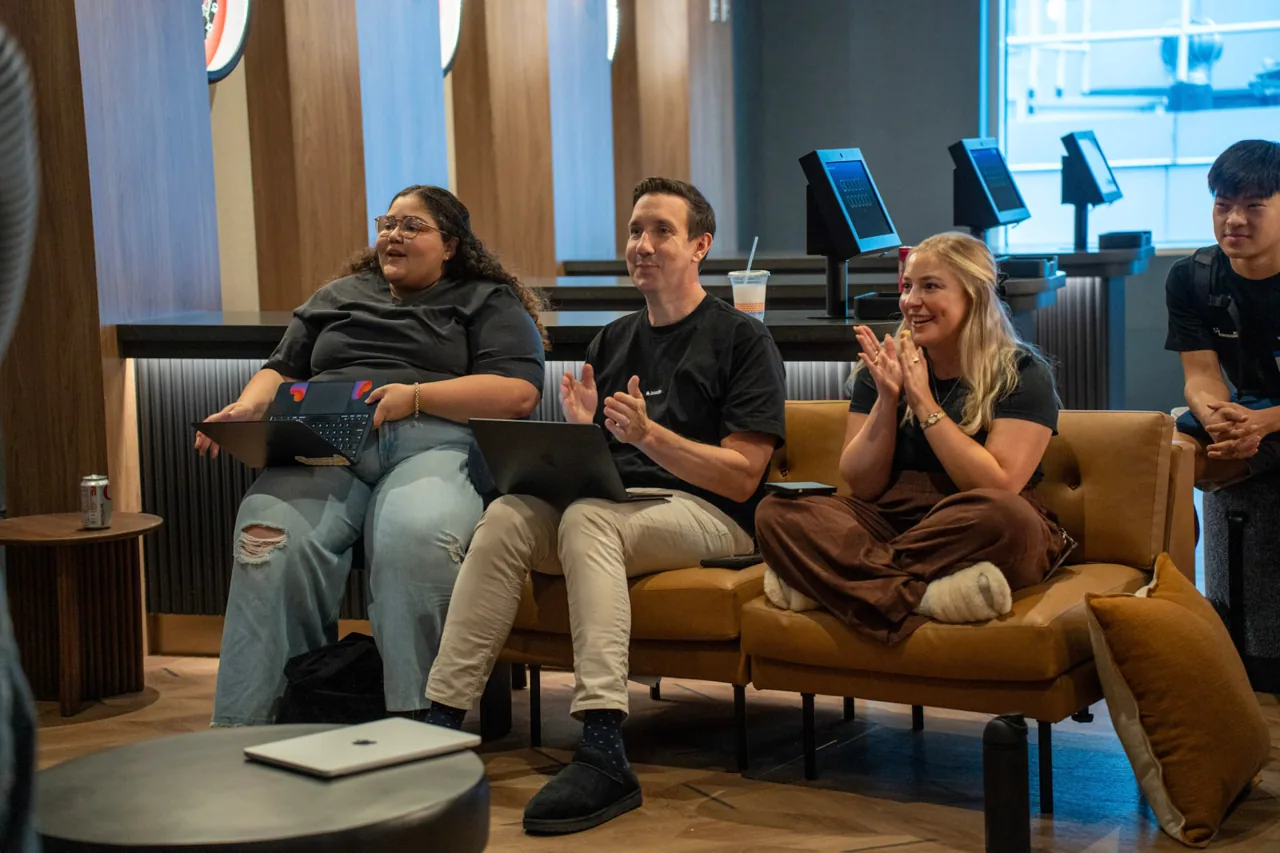 Ashley clapping with community members at a Lovable event