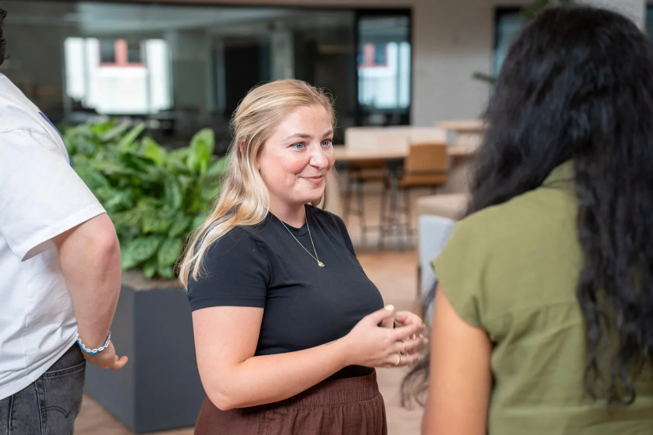 Ashley smiling in conversation at the Lovable office